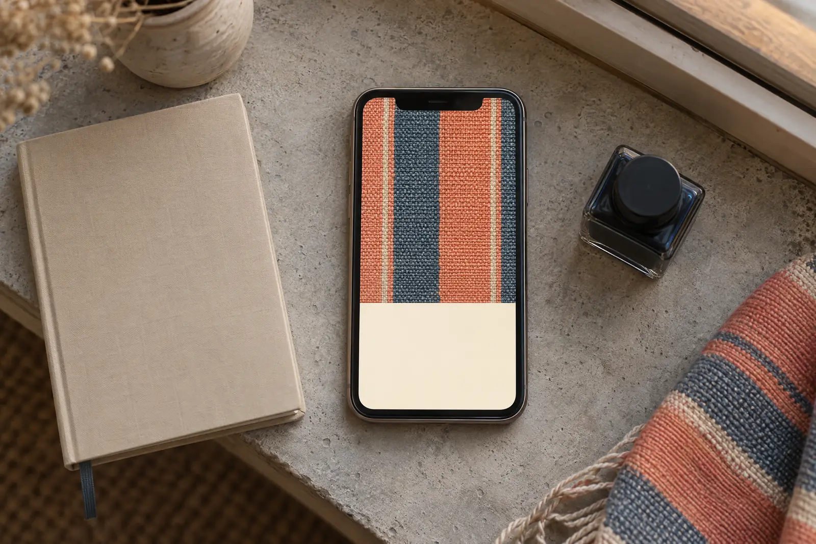 A writing cabin still life of a ebook product arranged with a small ink bottle, in coral, sand, slate, and cream.