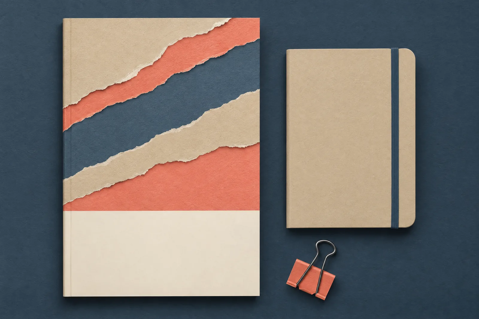 A paper studio still life of a ebook product arranged with a black binder clip, in coral, sand, slate, and cream.